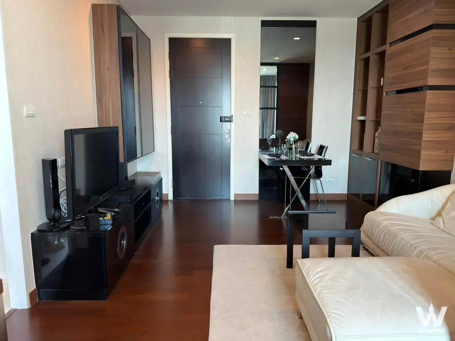 Cream sectional and dark wood console in the living room of this 1-bed IVY THONGLOR rental