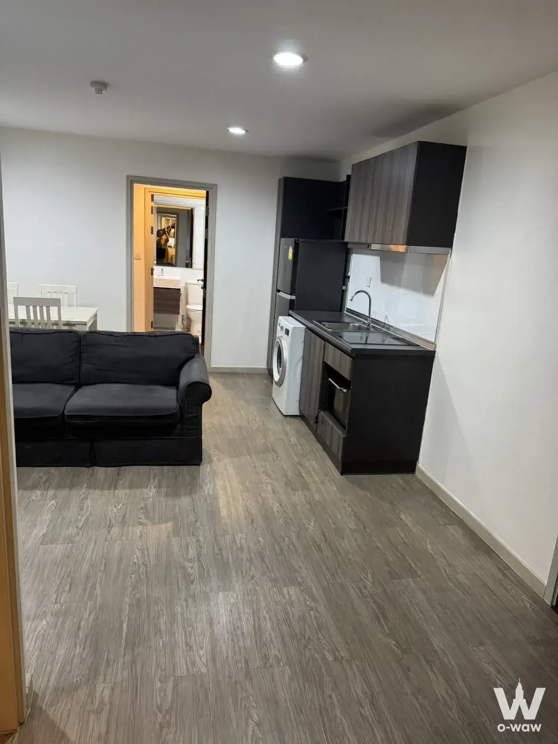 2-bed condo for rent in Villa Lasalle with grey laminate flooring and compact kitchenette