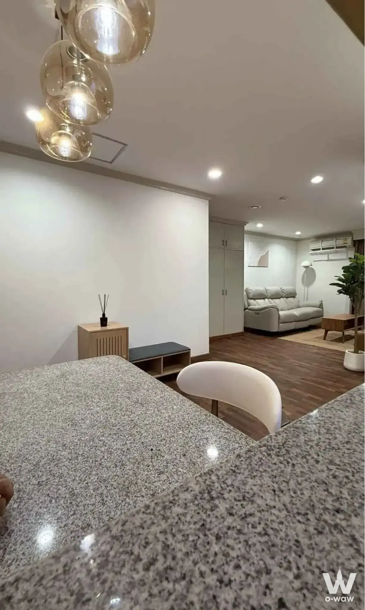 1-bed condo for rent in Sampoom Garden Condominium with amber pendant lights and recliner