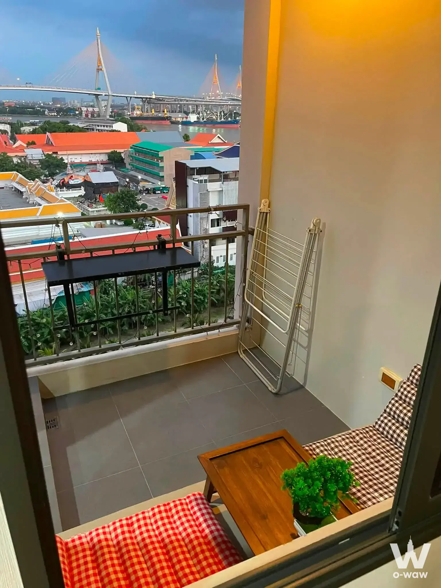 Narrow balcony at U Delight Residence with river view and small table