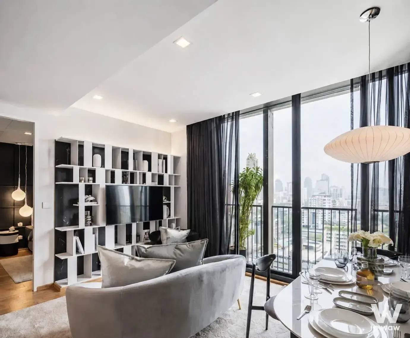 Open-plan Noble Around Sukhumvit 33 living space with velvet sofa and dining table for six