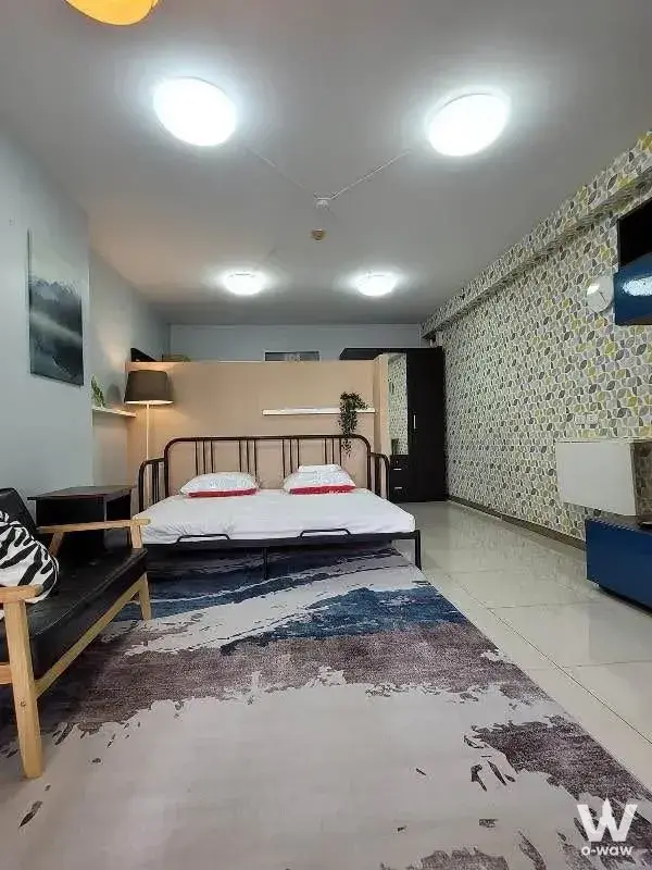 Compact studio bedroom in City Home Sukhumvit with geometric wallpaper and double bed