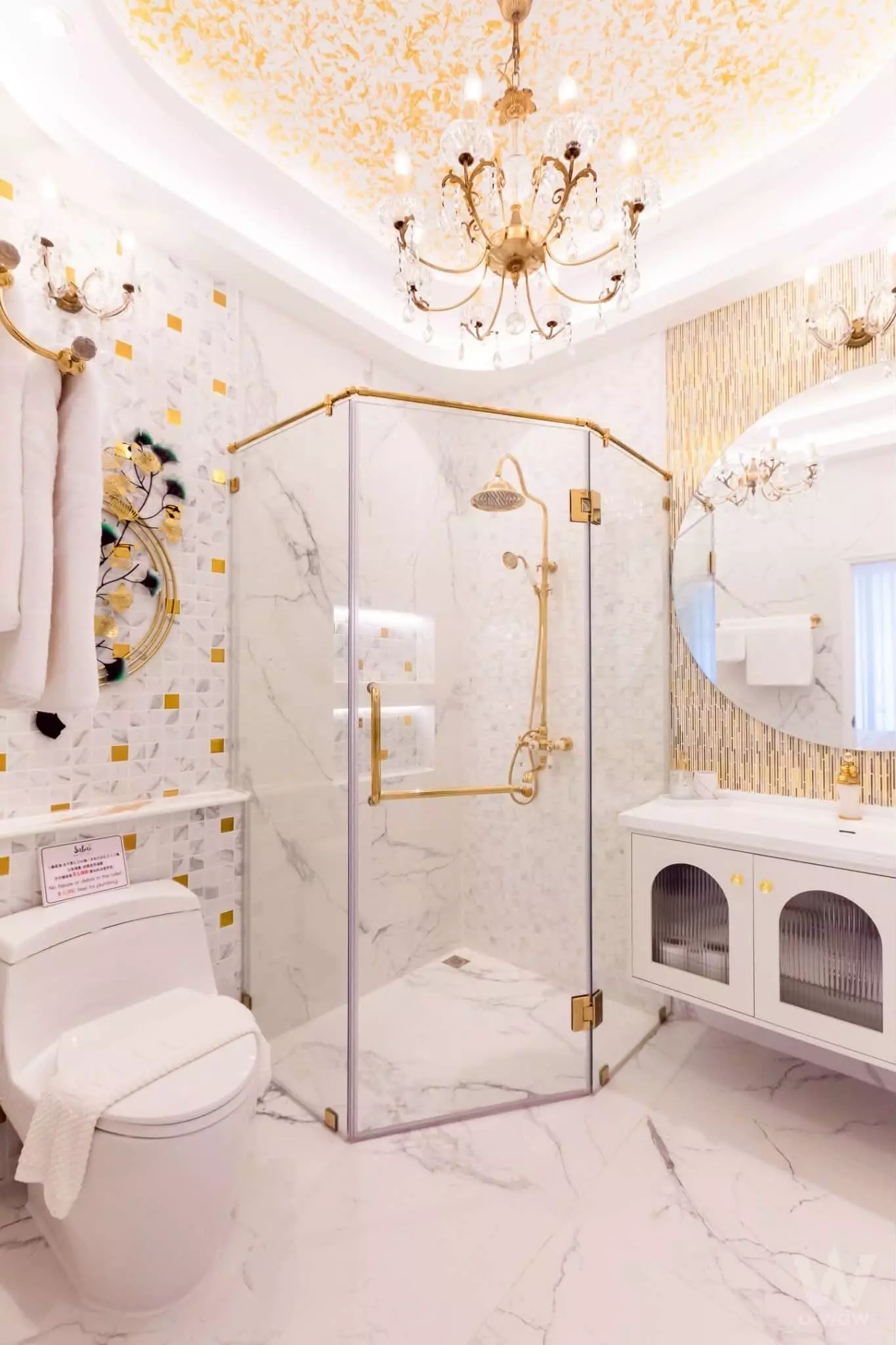 Luxury bathroom in The Freda SabaiSpace with gold fixtures and white marble floors