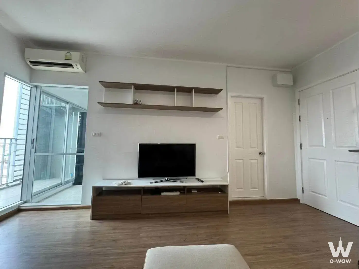 Modern 2-bed condo living room at U Delight Talat Phlu with floating shelves and balcony access