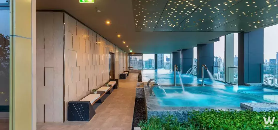 Rooftop infinity pool with arched jets and city views at this 3-bed rental in The Issara Sathorn