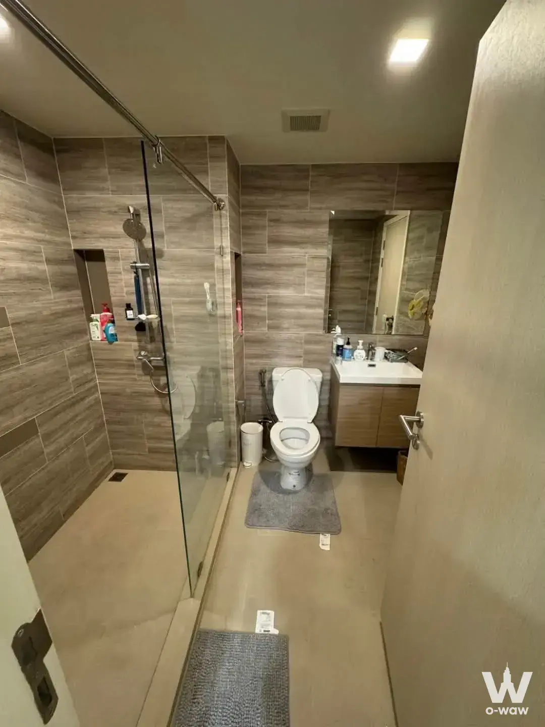 Maestro 03 Ratchada-Rama 9 bathroom featuring grey tile walls, walk-in shower, and floating vanity