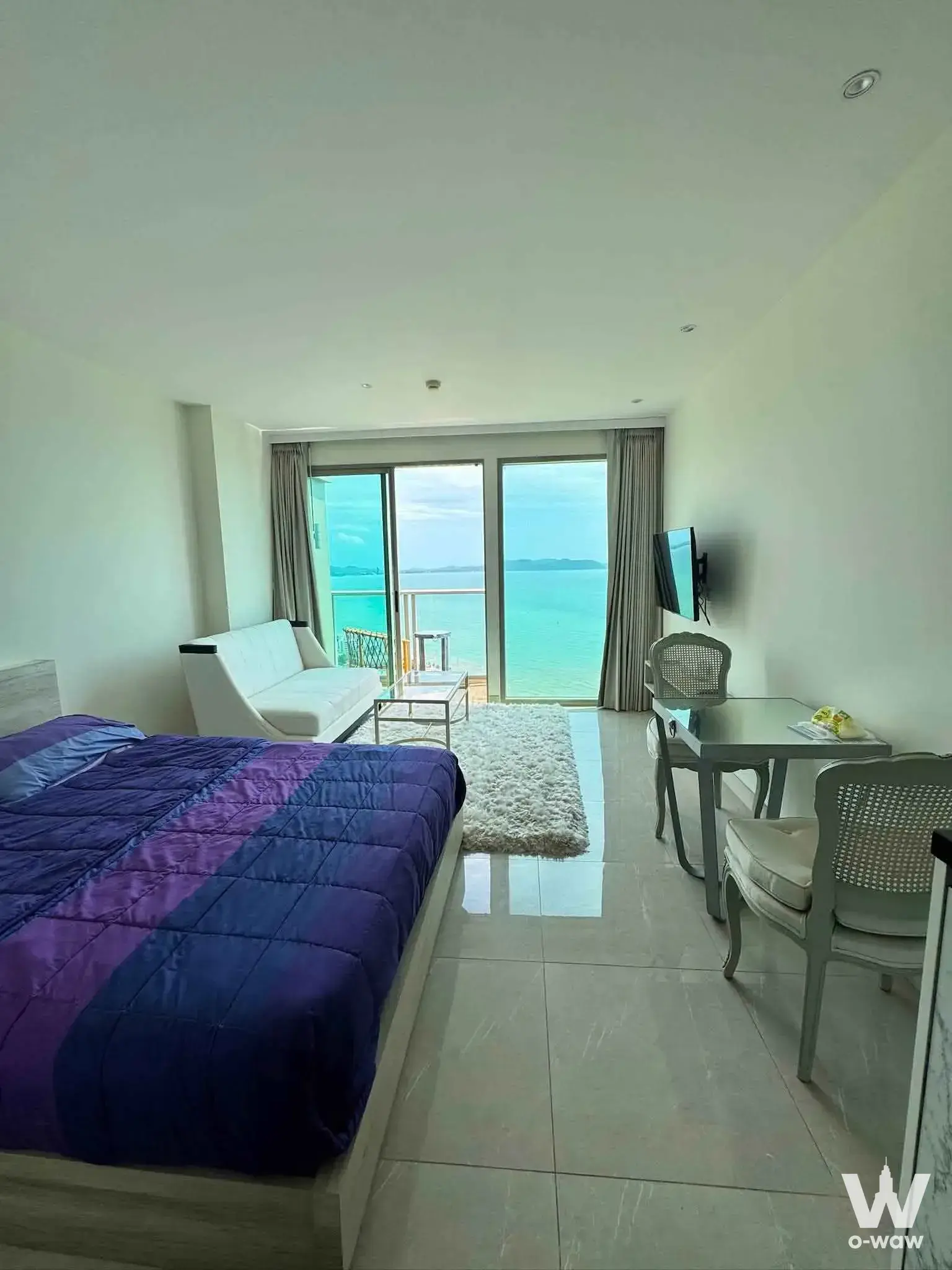 Bedroom with queen bed and direct balcony access to ocean views at The Riviera Monaco