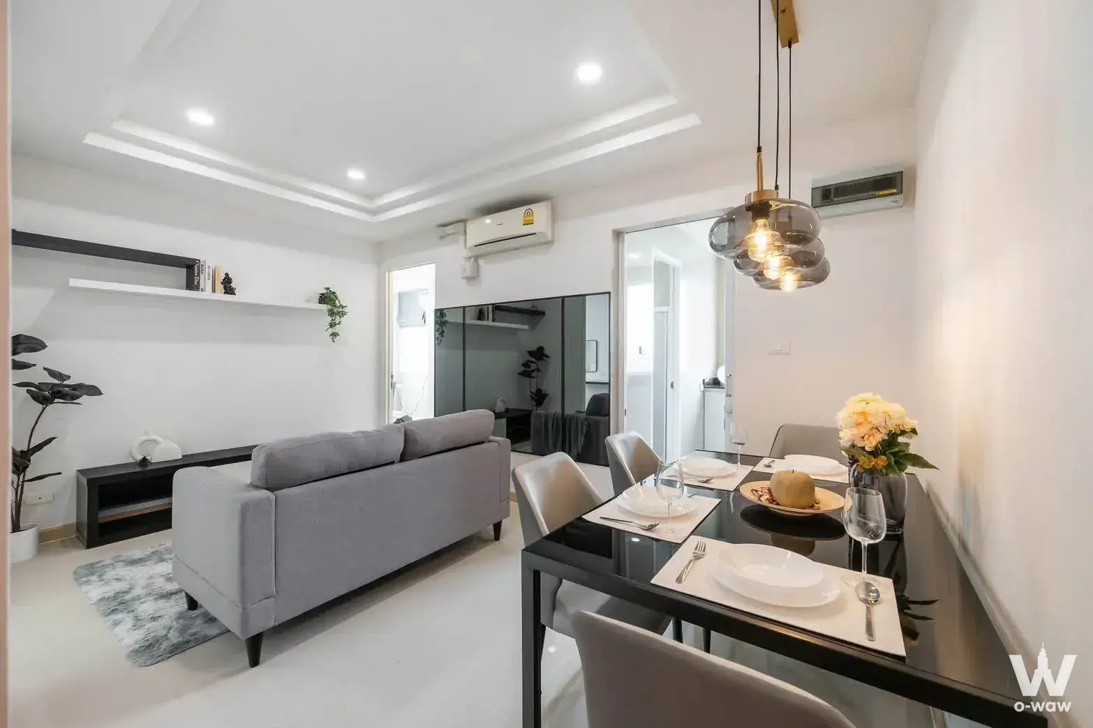 2-bed condo for rent in Happy condo ladprao living room with black glass dining table and pendant light