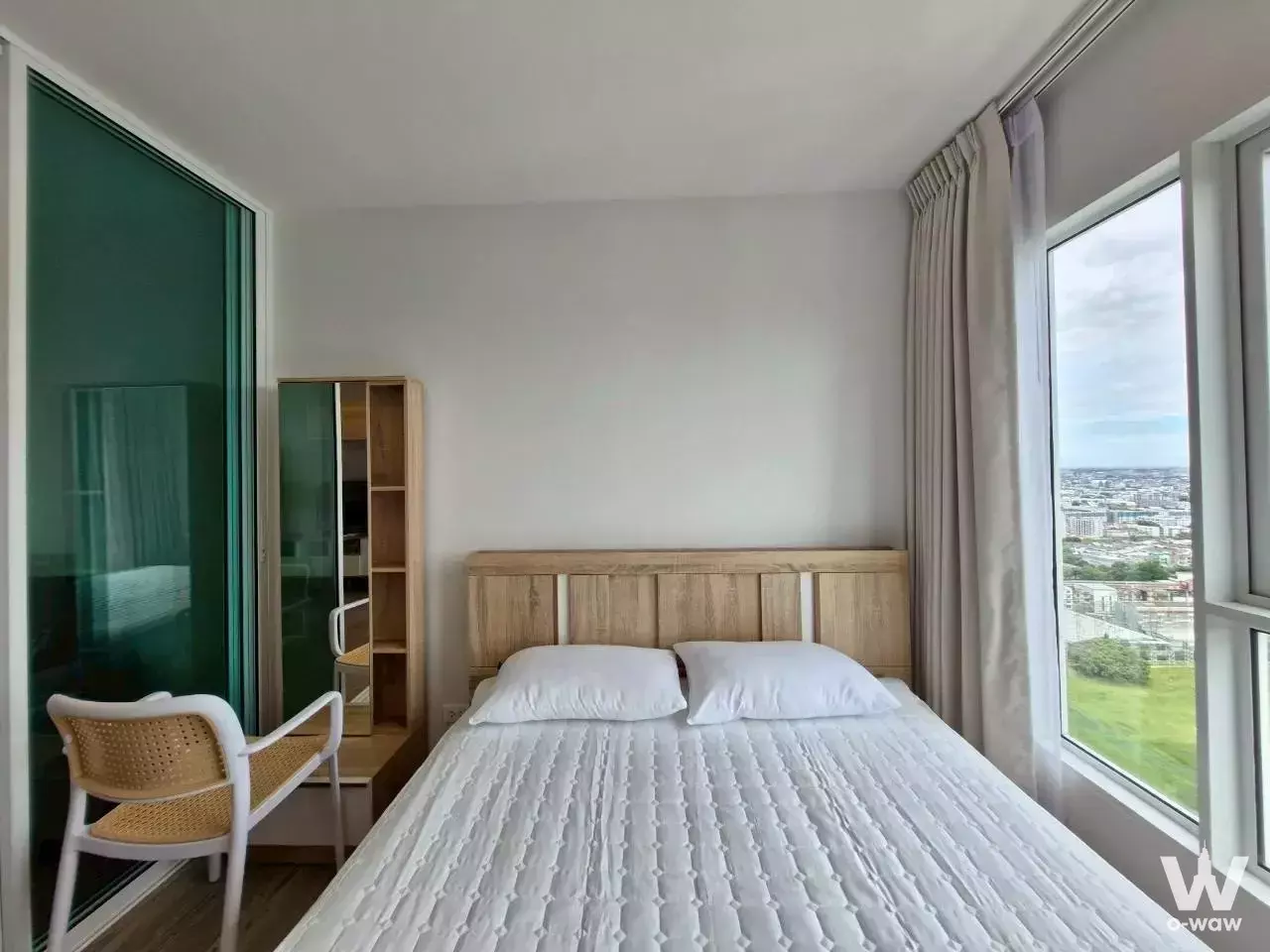 Bedroom in a 1-bed condo for rent in Regent Home Bangna with glass partition and park views