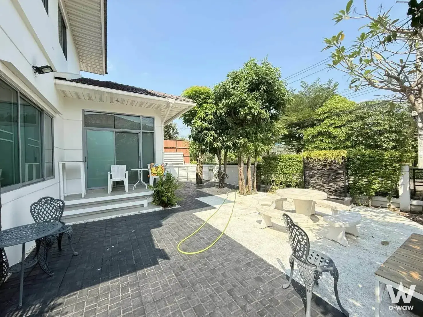 Backyard of Perfect Place Chaengwattana 2 featuring stone picnic set patio chairs and lush greenery