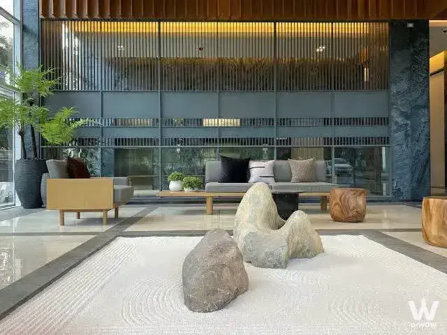 Zen lobby with raked sand garden and modern seating at Siamese Exclusive Sukhumvit 42 rental