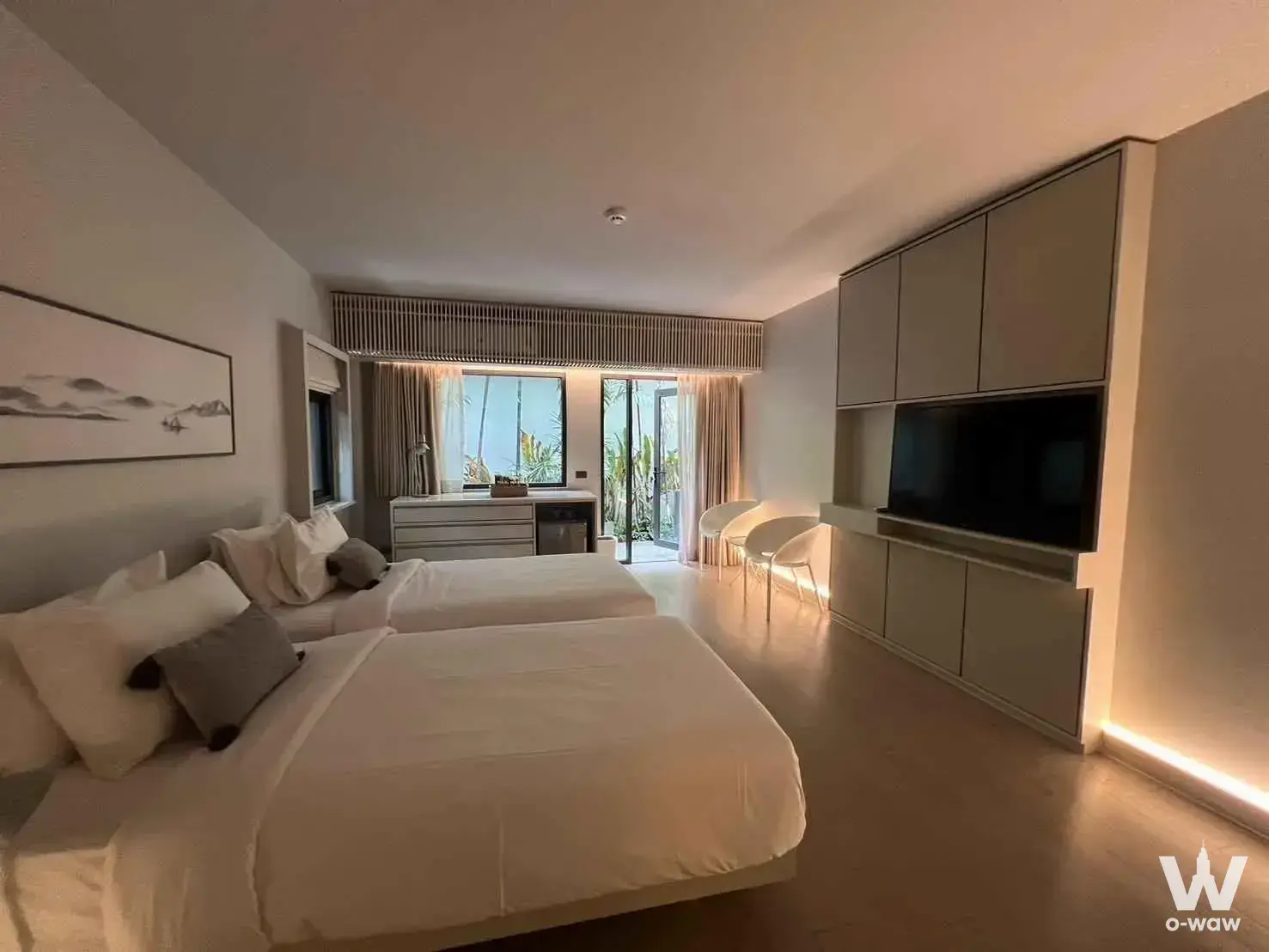 Bedroom in a 6-bed house for rent in Tree Villa Bangkok with two queen beds, a wall-mounted TV, and balcony access to