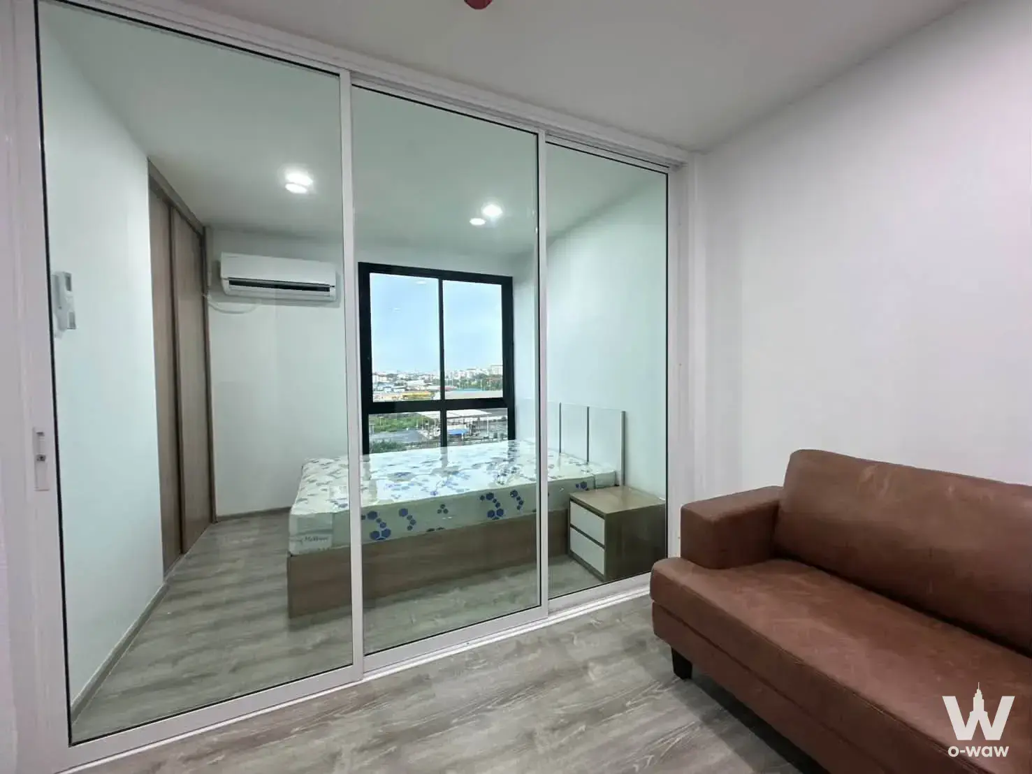 Studio in i-Condo 1 Salaya with sliding glass partition, city view, and minimalist furnished layout