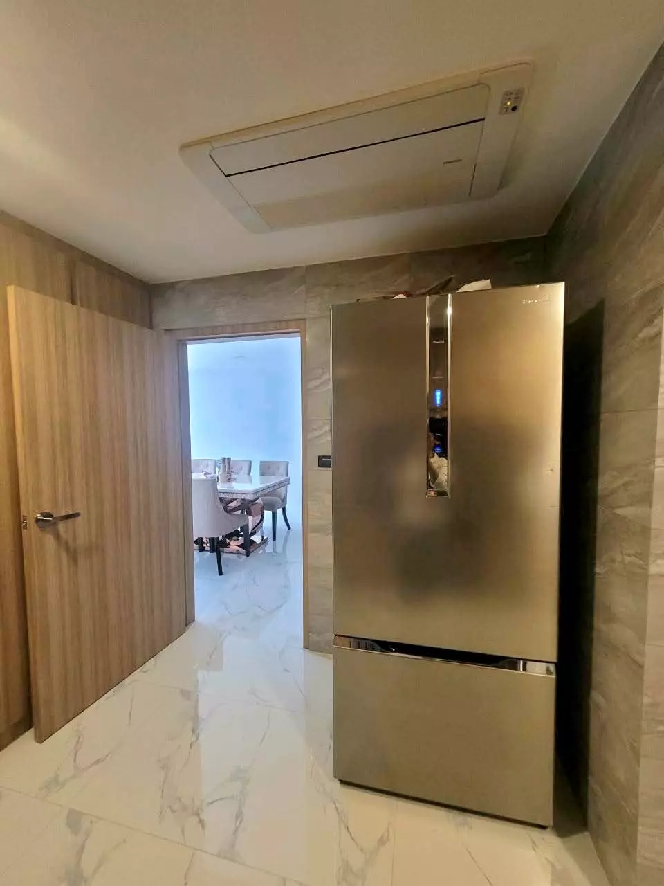 Entry hallway in a 3-bed condo for rent at President Park with marble floors and stainless-steel refrigerator