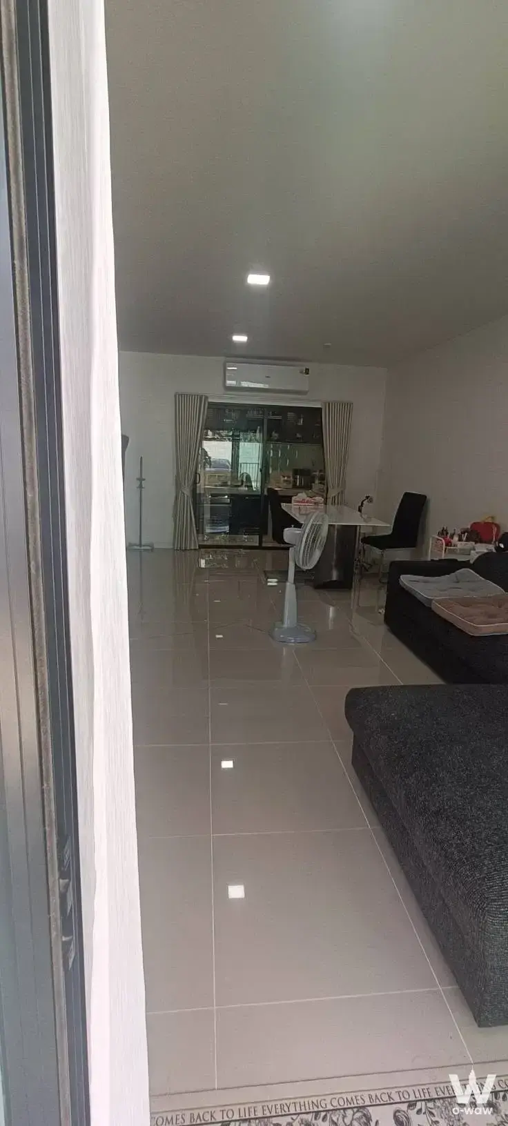 Open-plan living room in 3-bed townhouse for rent in The Connect km.8 with grey tile flooring
