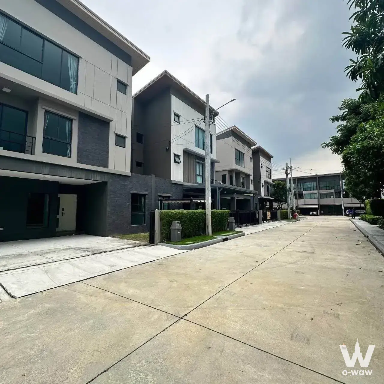 Modern townhouse exterior in Baan Klang Mueng Ramintra 83 Station with dark grey brick facades