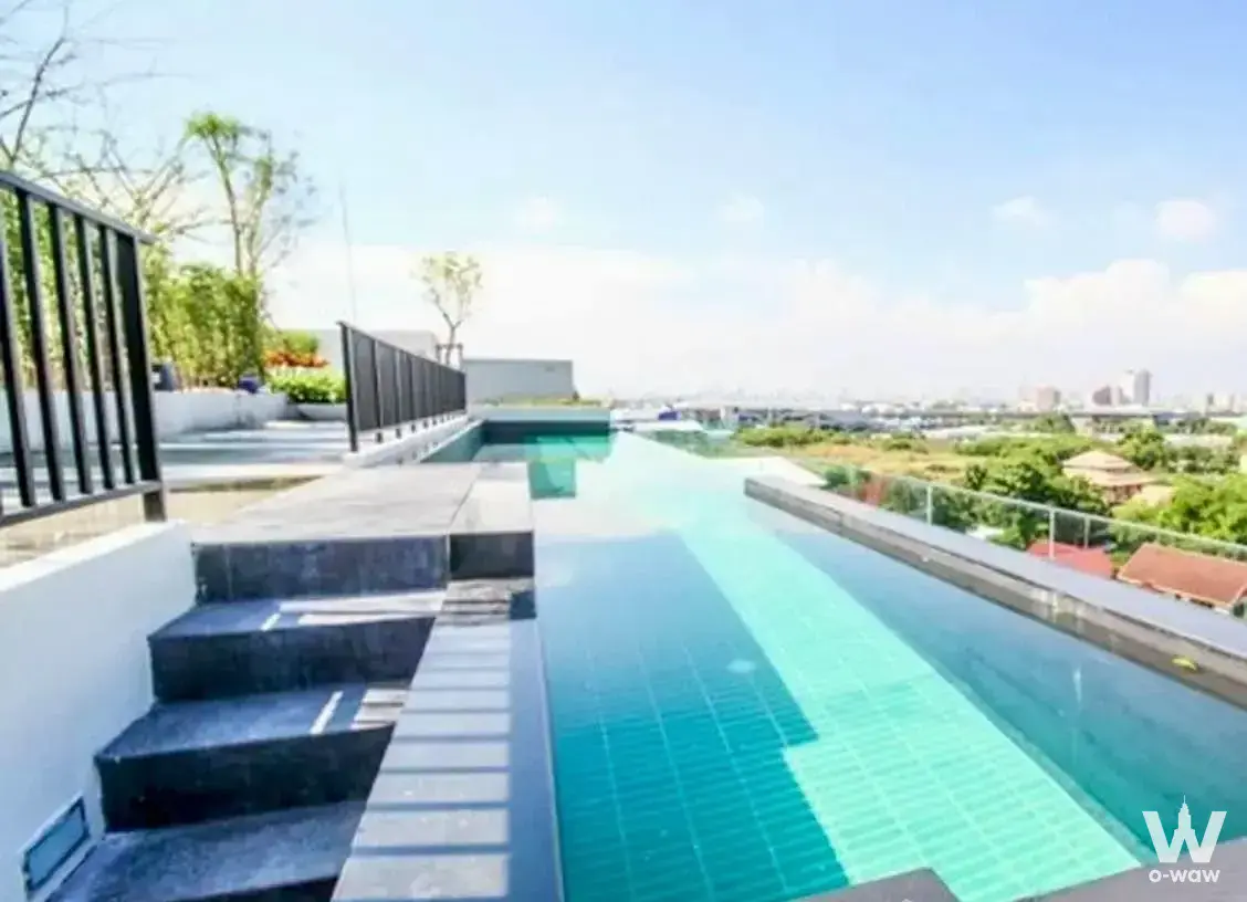 Pause Sukhumvit 107 rooftop infinity pool with turquoise tiles and panoramic city views