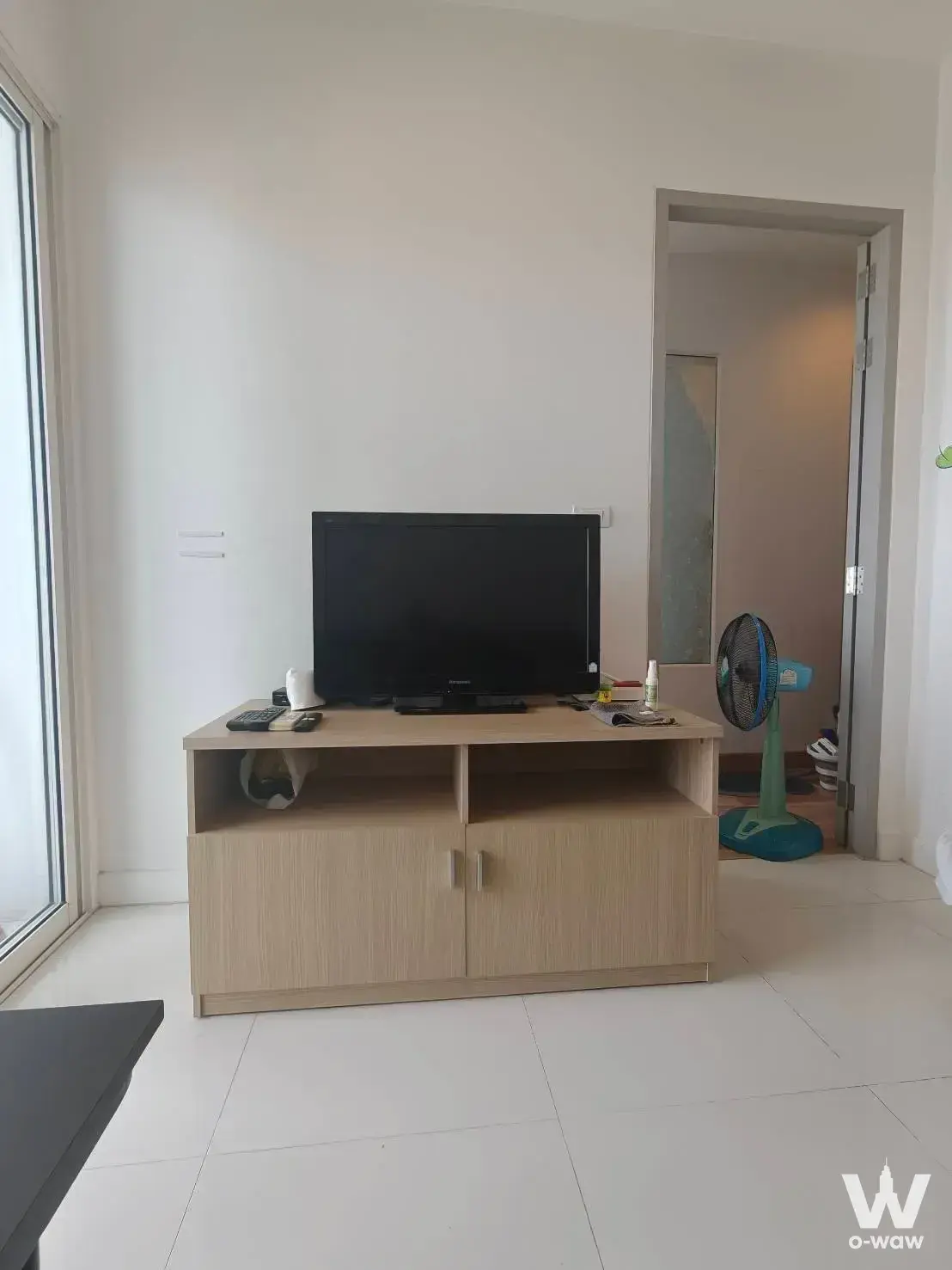 Bright living area in an Ideo Verve Sukhumvit rental featuring floor-to-ceiling windows and light oak TV console