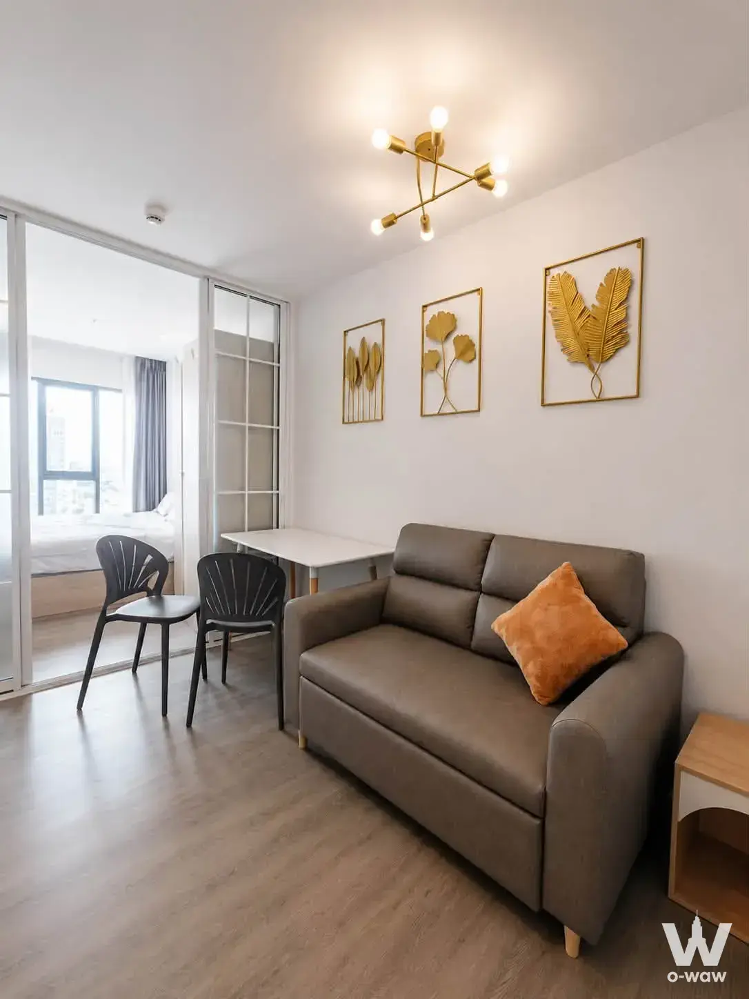 Grey sofa bed with gold accents in this 1-bed studio for rent at Regent Home Wutthakat