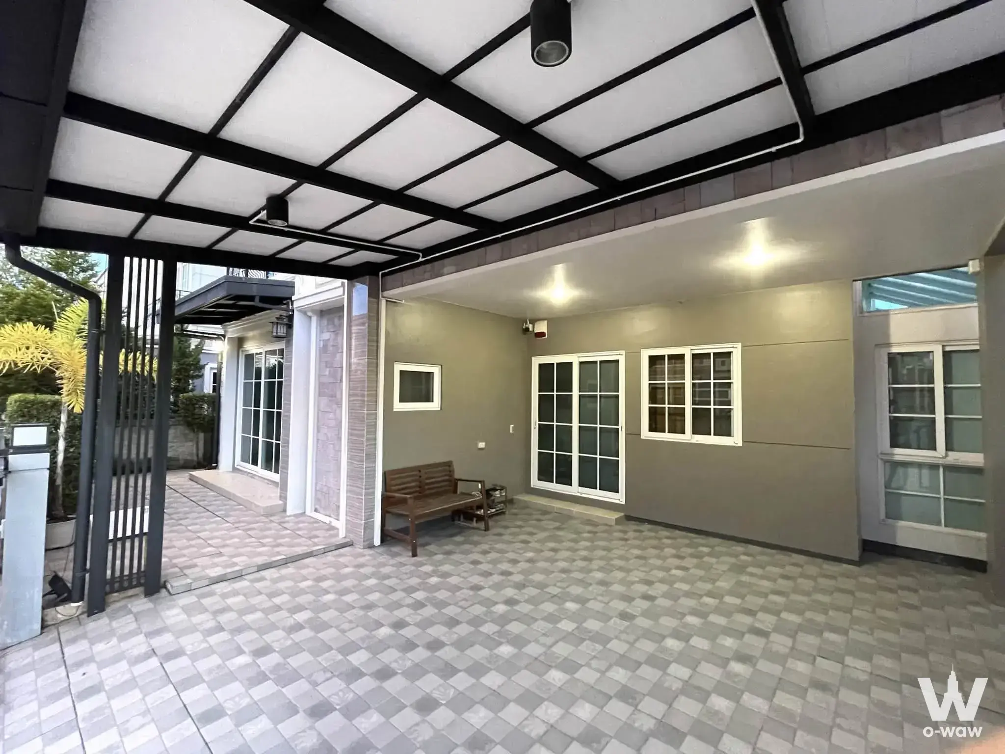 Covered front patio with checkerboard tiles and French doors at a 4-bed house in Golden Neo Sathorn