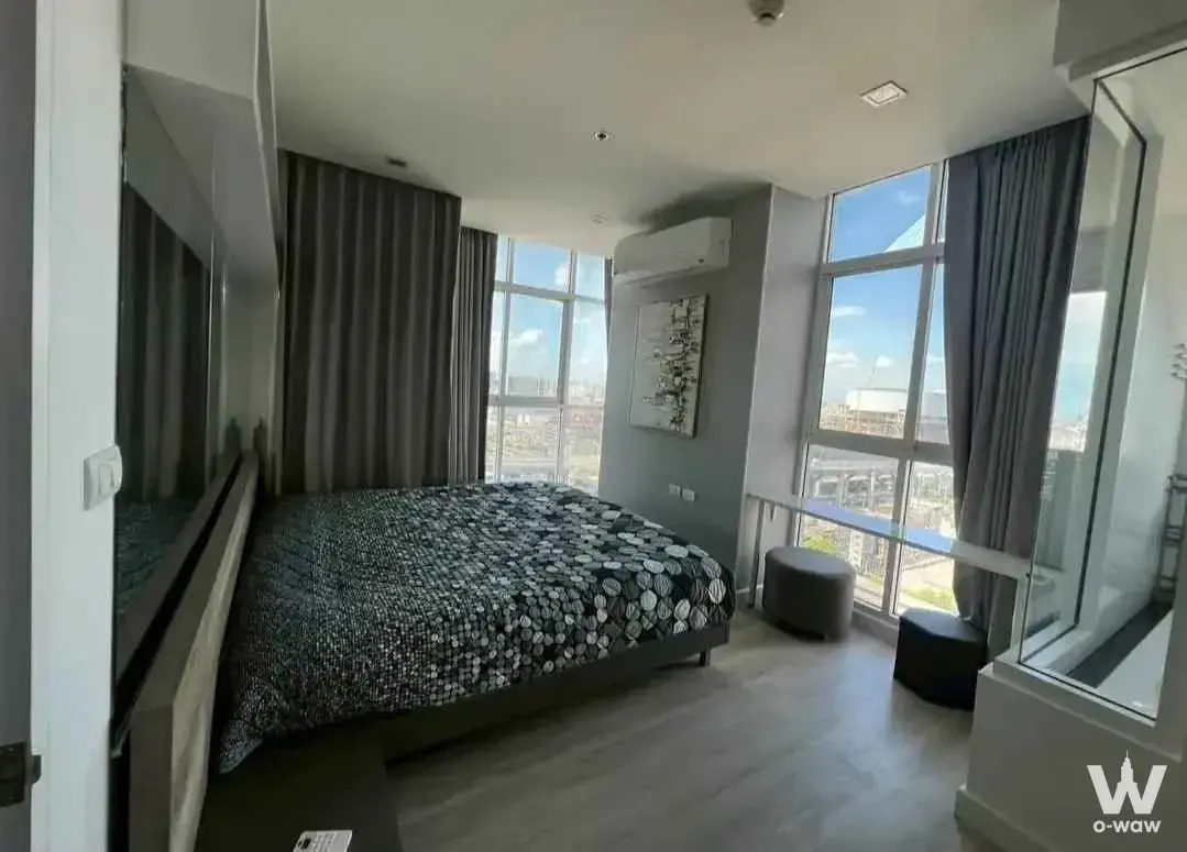 Bedroom with city skyline view in a 2-bed condo for rent in The Coast Bangkok