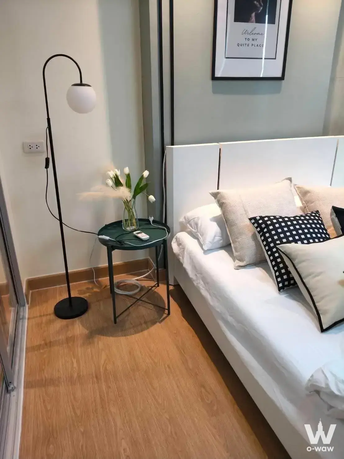 Bedroom in 1-bed condo for rent at Dcondo Rattanathibet with queen bed, white linens, and minimalist decor