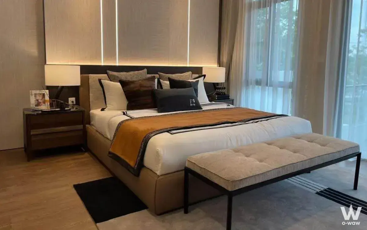 Master bedroom in Mantana Bangna 4-bed house with king bed, leather bench, and floor-to-ceiling windows