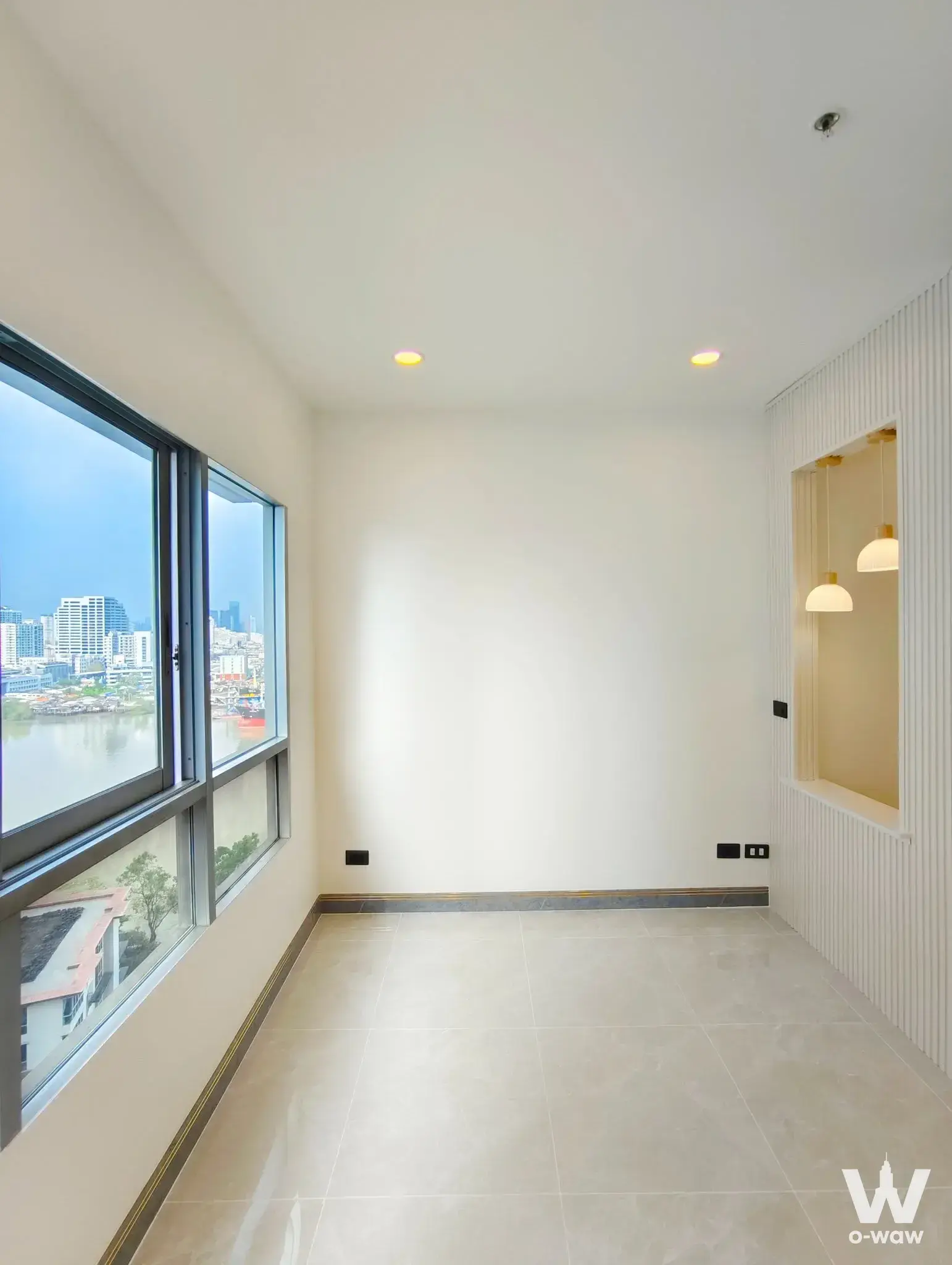 Empty 1-bed Ivy River condo with river views and gold-accented lighting niche
