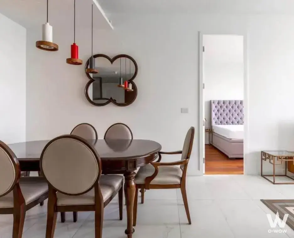 Dining room in 2-bed condo at 185 Rajadamri with round table, pendant lights, and mirror