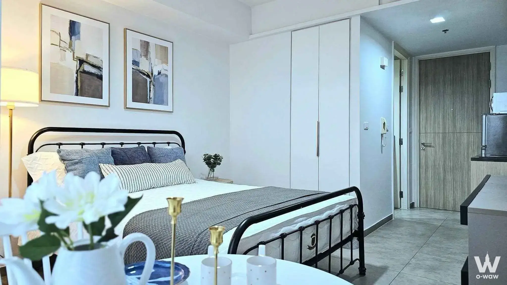 Staged bedroom with black metal bed frame in Unixx South Pattaya 1-bed condo