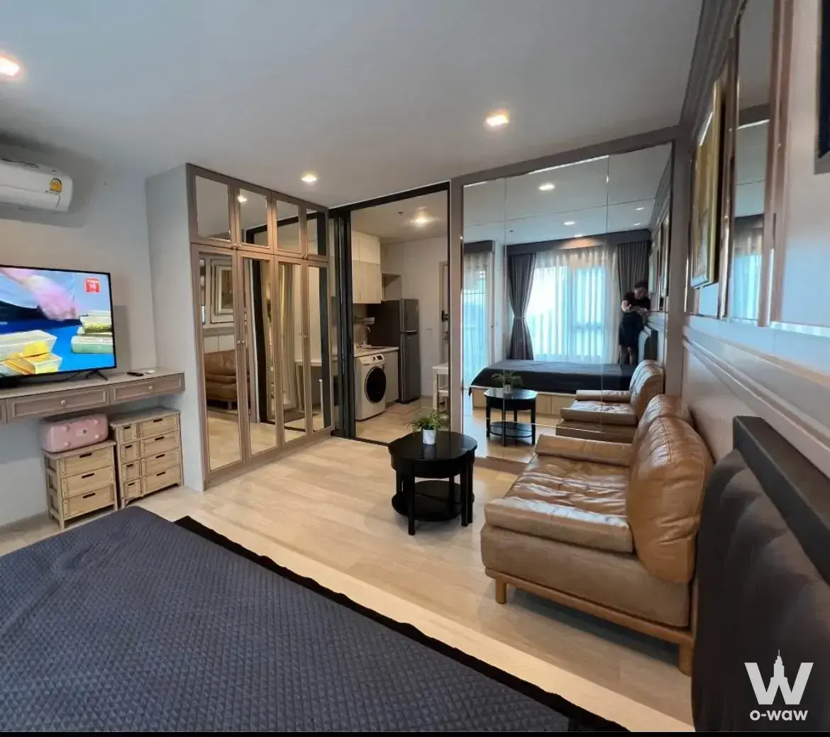 1-bed condo for rent in Life One Wireless featuring a modern open-plan layout with light wood floors and mirrored wardrobe