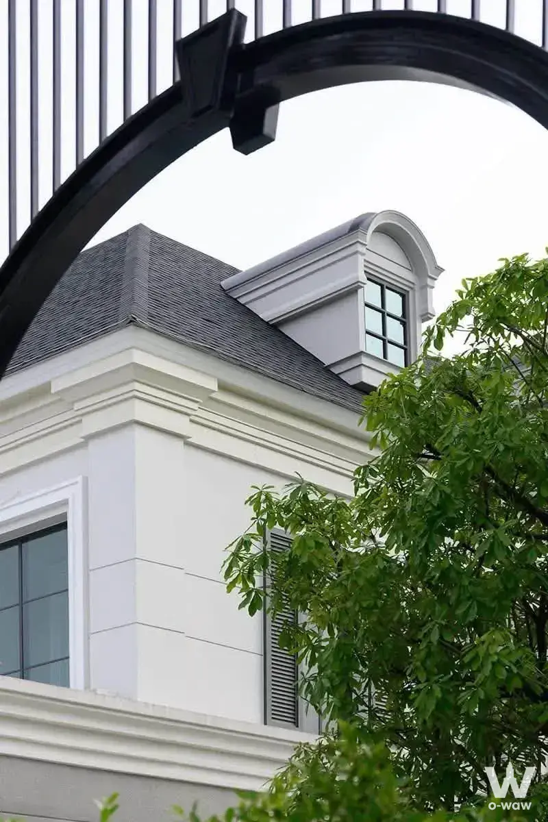 Classical white stucco facade and dormer window of a 0-bed house for sale in Setthasiri Bangna KM.10