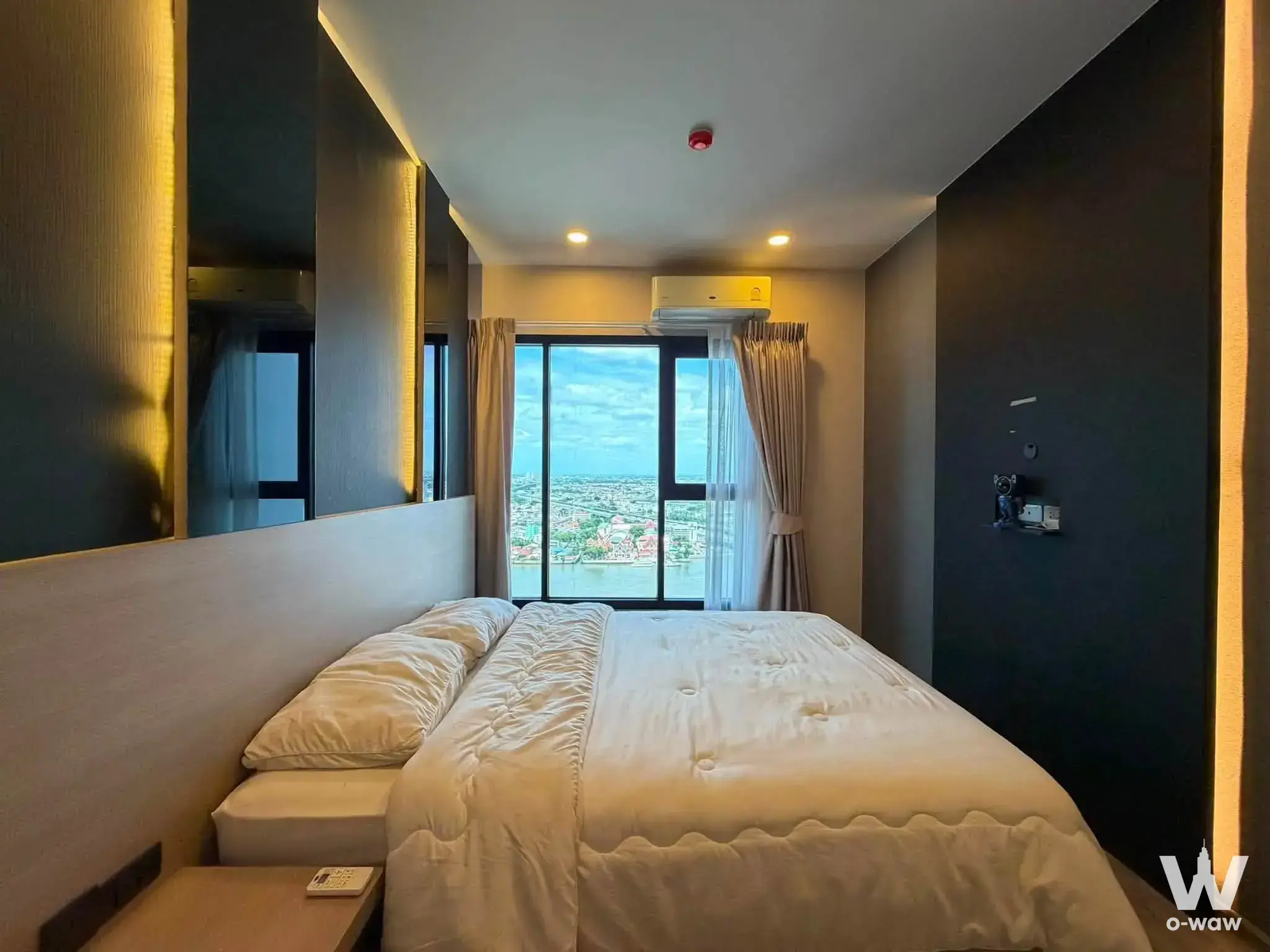 Bedroom in Chapter One Flow Bangpo rent listing with charcoal accent wall and river view