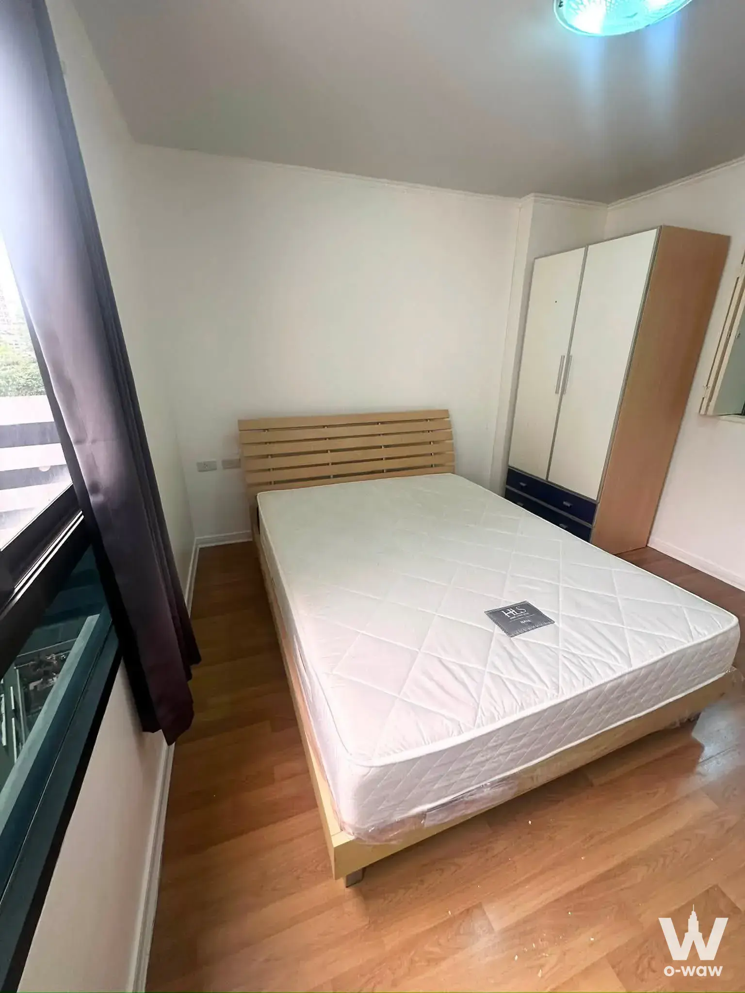 Queen-size bed in a modern 1-bed house for rent at Home Lumpini Place Narathiwas - Chaopraya