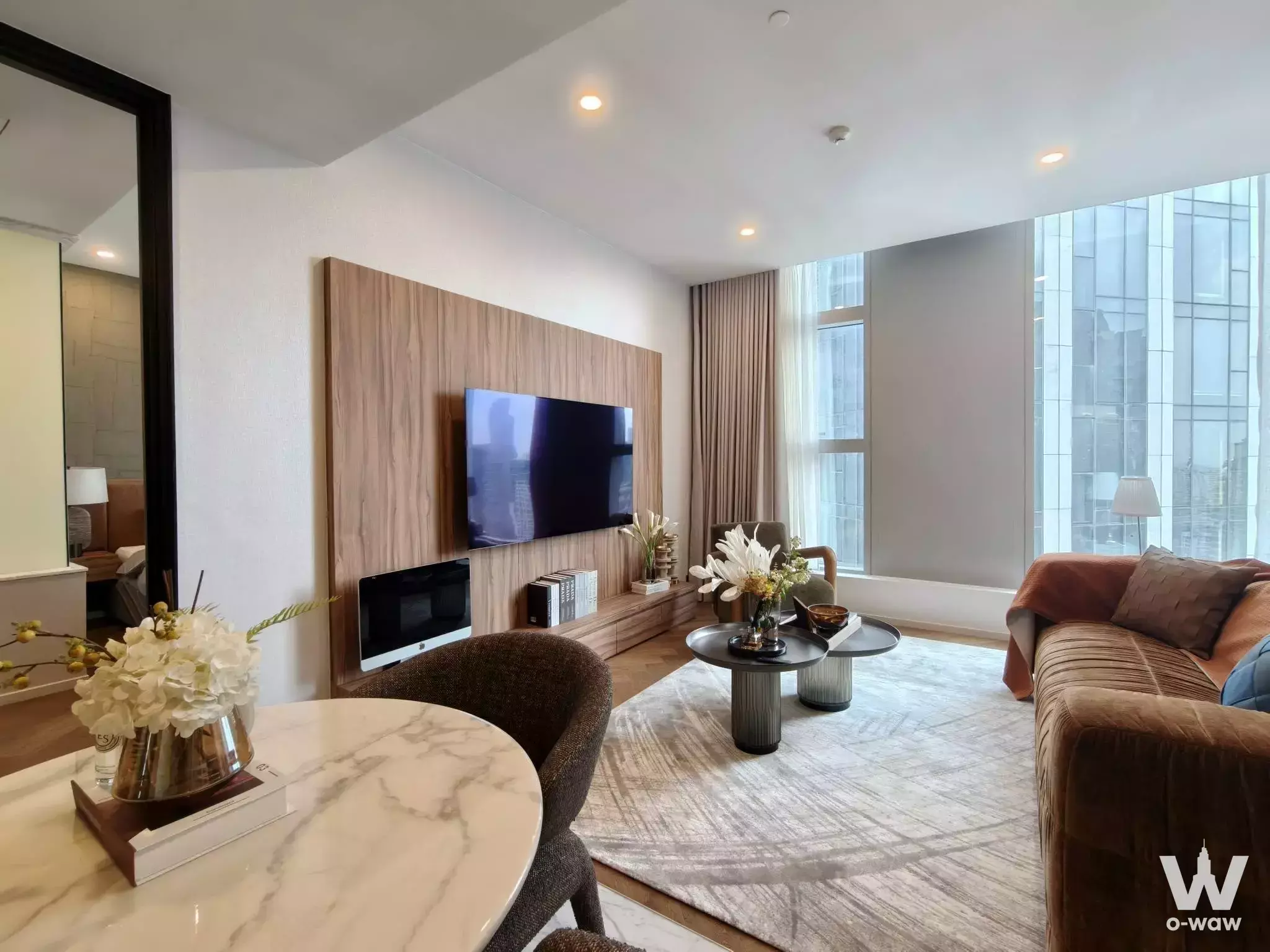 Luxury living room in The Residences 38 featuring a wood feature wall, velvet sofa, and city views