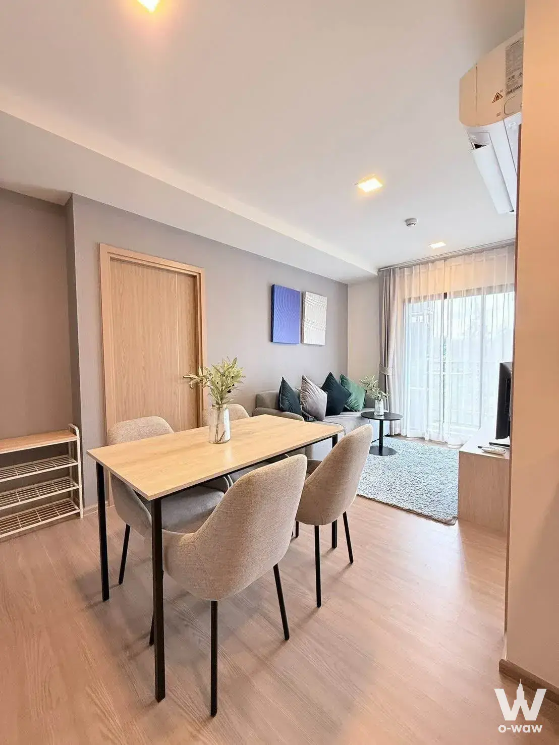 2-bed condo for rent in The Base Bukit Phuket featuring light wood dining set and minimalist decor
