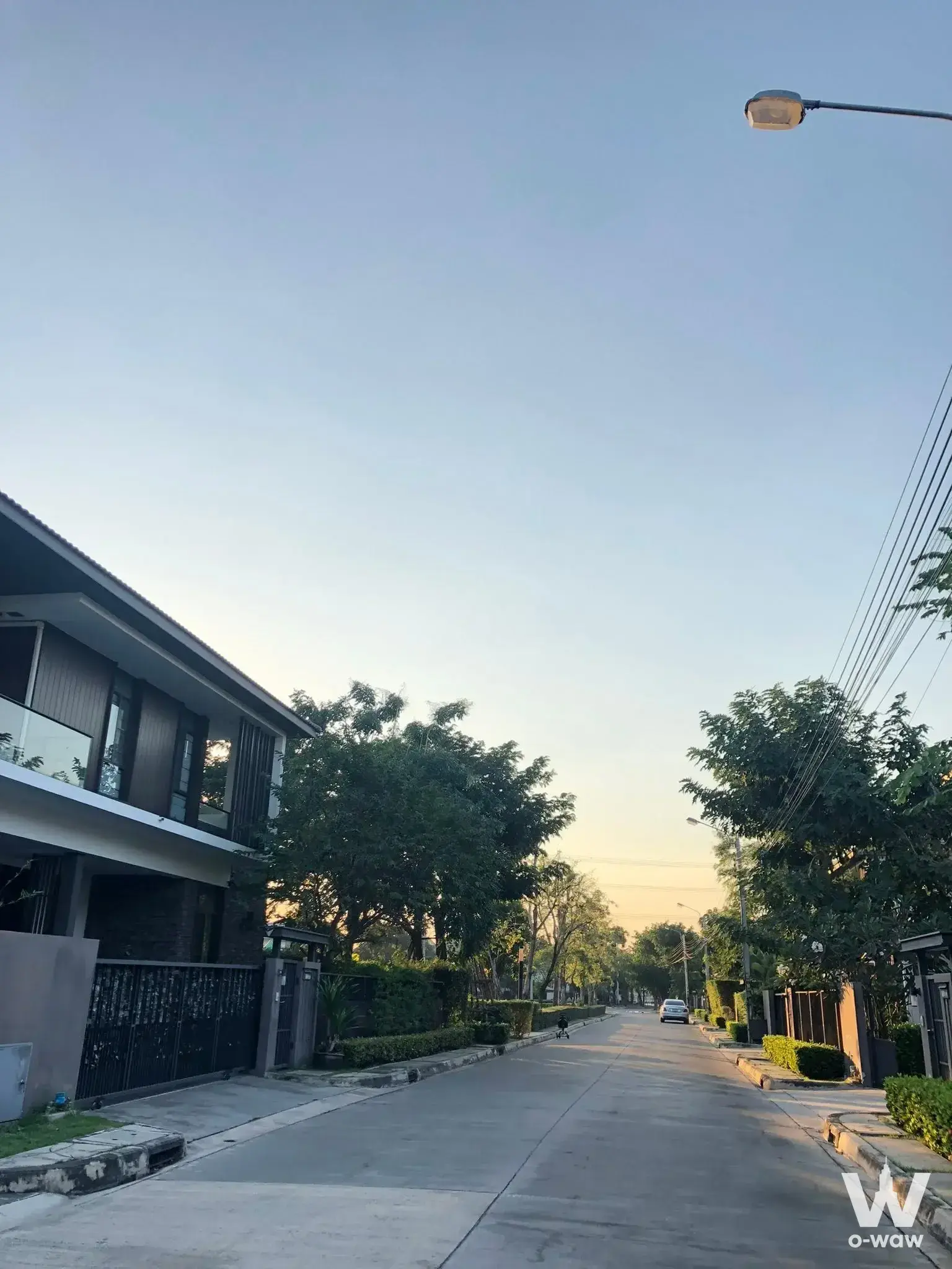 Modern two-story house exterior on quiet street in Mantana Onnut-Wongwaen 3