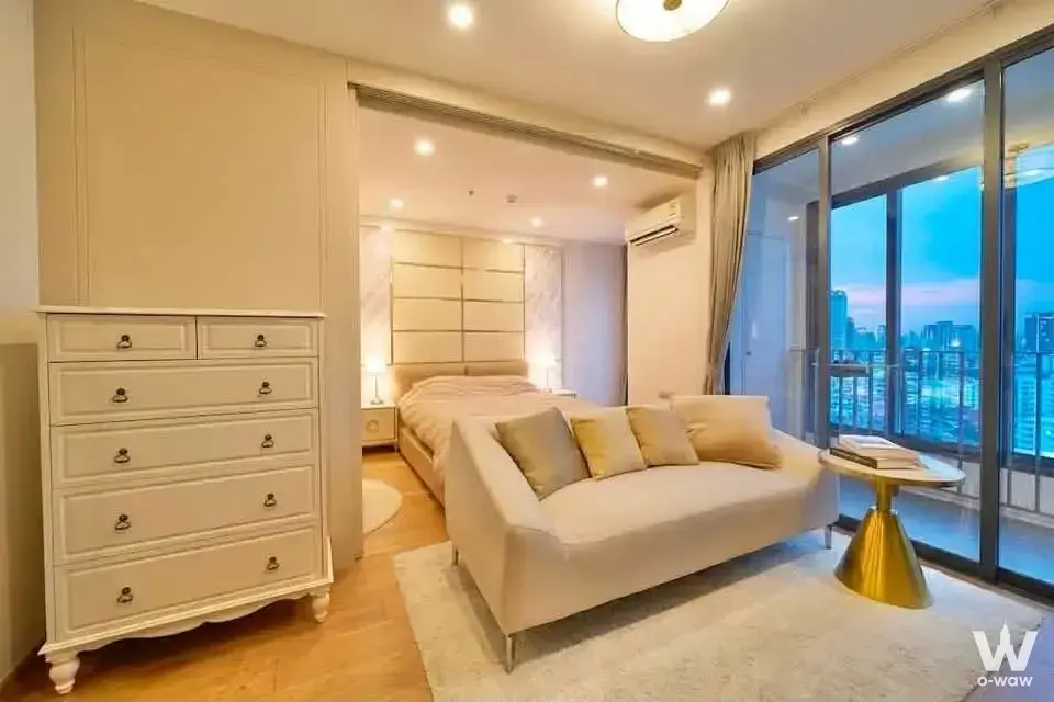 Cream bedroom with gold accents and city view in Q Chid Lom Phetchaburi condo