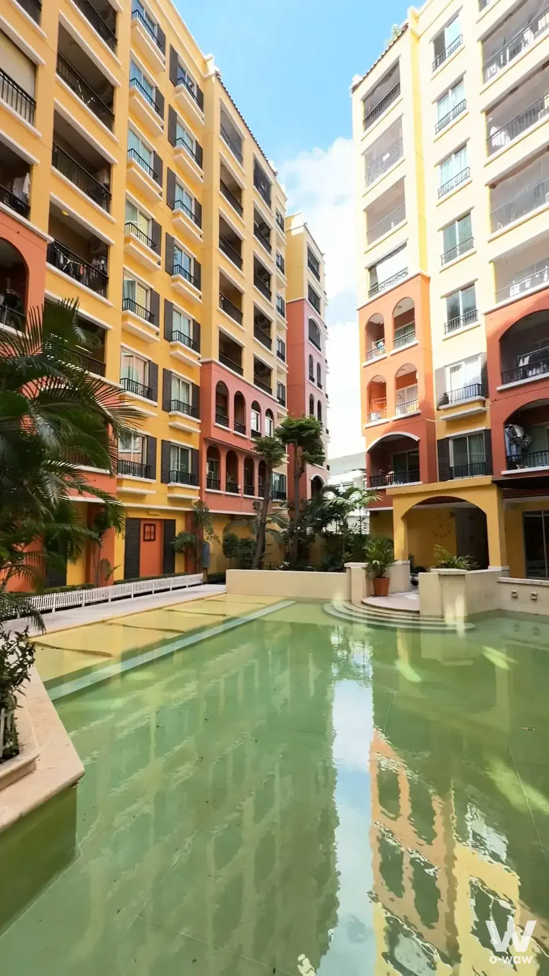 The Seed Terre 2-bed condo courtyard pool with terracotta facades and palm trees