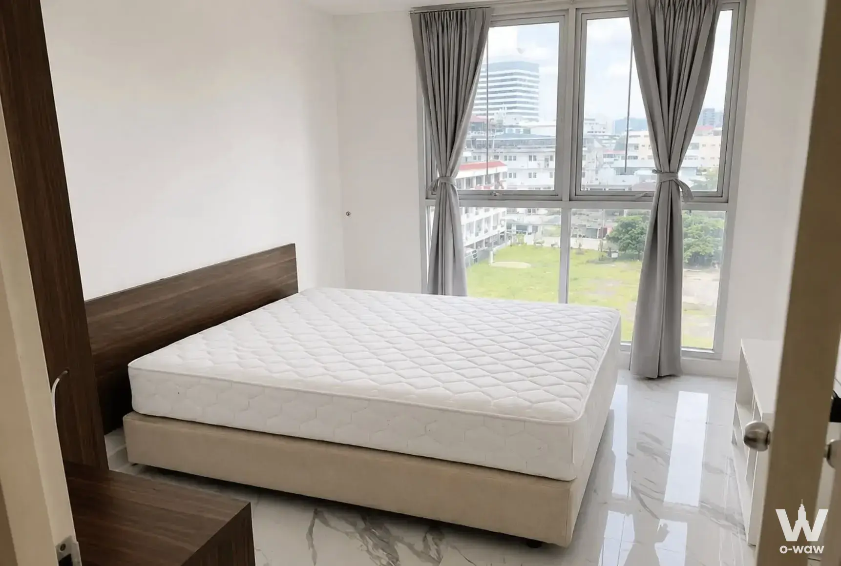 Bedroom with city view and white marble-look tile floor in a 1-bed condo for sale in The Niche Sukhumvit 49