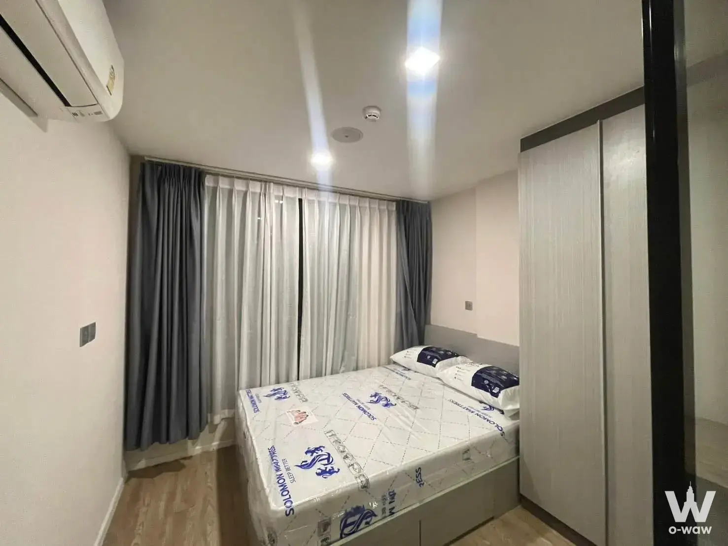 Bedroom in ATMOZ Ladprao 15 2-bed condo featuring built-in wardrobe and window