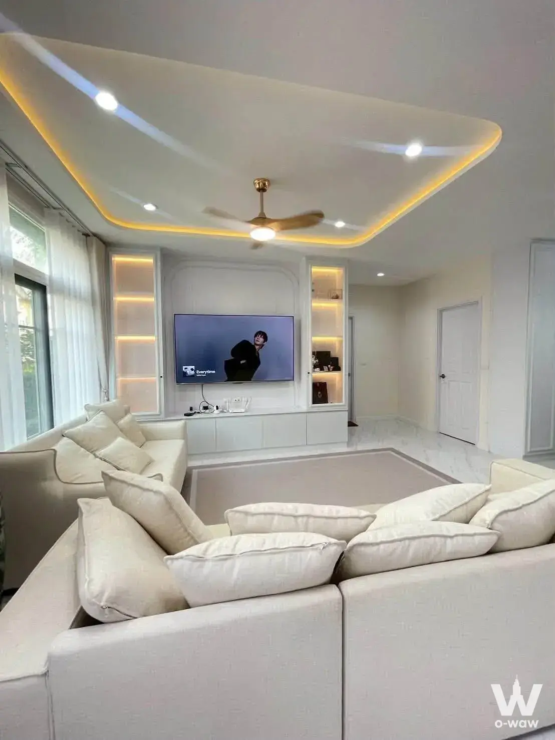 Grandio Bangna 5-bed house living room with built-in media unit, gold fan, and recessed tray ceiling