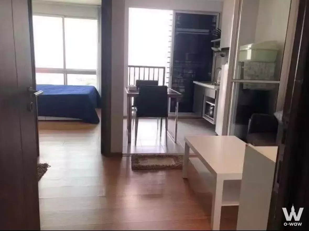 Open plan studio with kitchenette and bed alcove in a 1-bed condo at THE BASE Sukhumvit 77