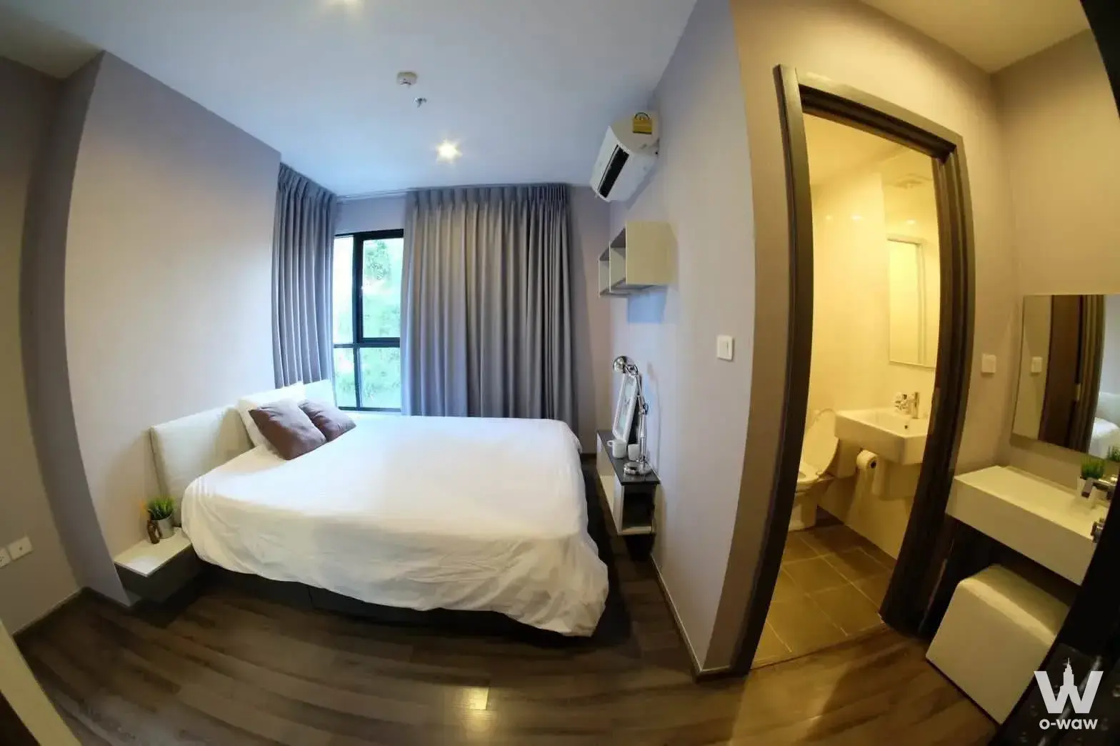 Bedroom with en-suite bathroom and vanity in a furnished THE BASE Park West unit