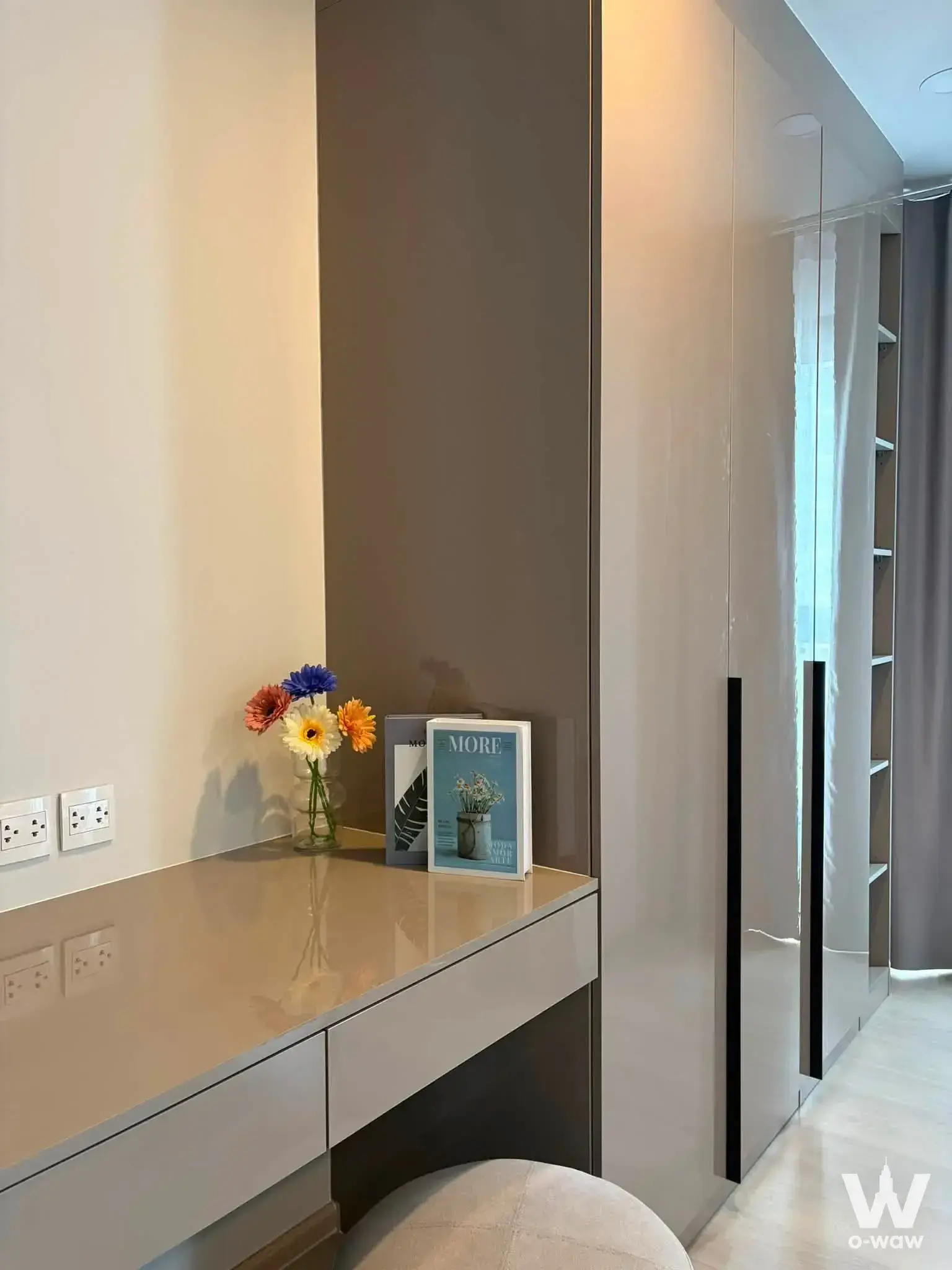 Dressing area in an Aspire Onnut Station 1-bed condo with beige gloss vanity and built-in wardrobes