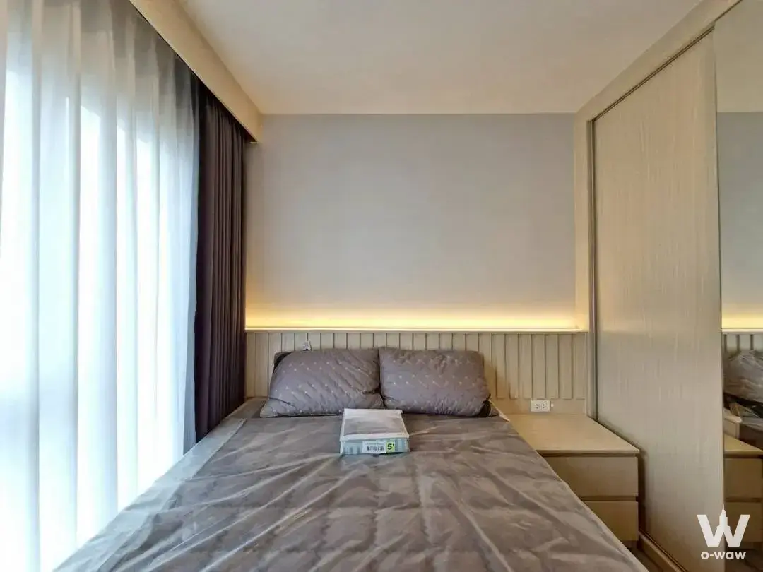 Regent Home Bangna bedroom with grey quilted bed and wood slat headboard