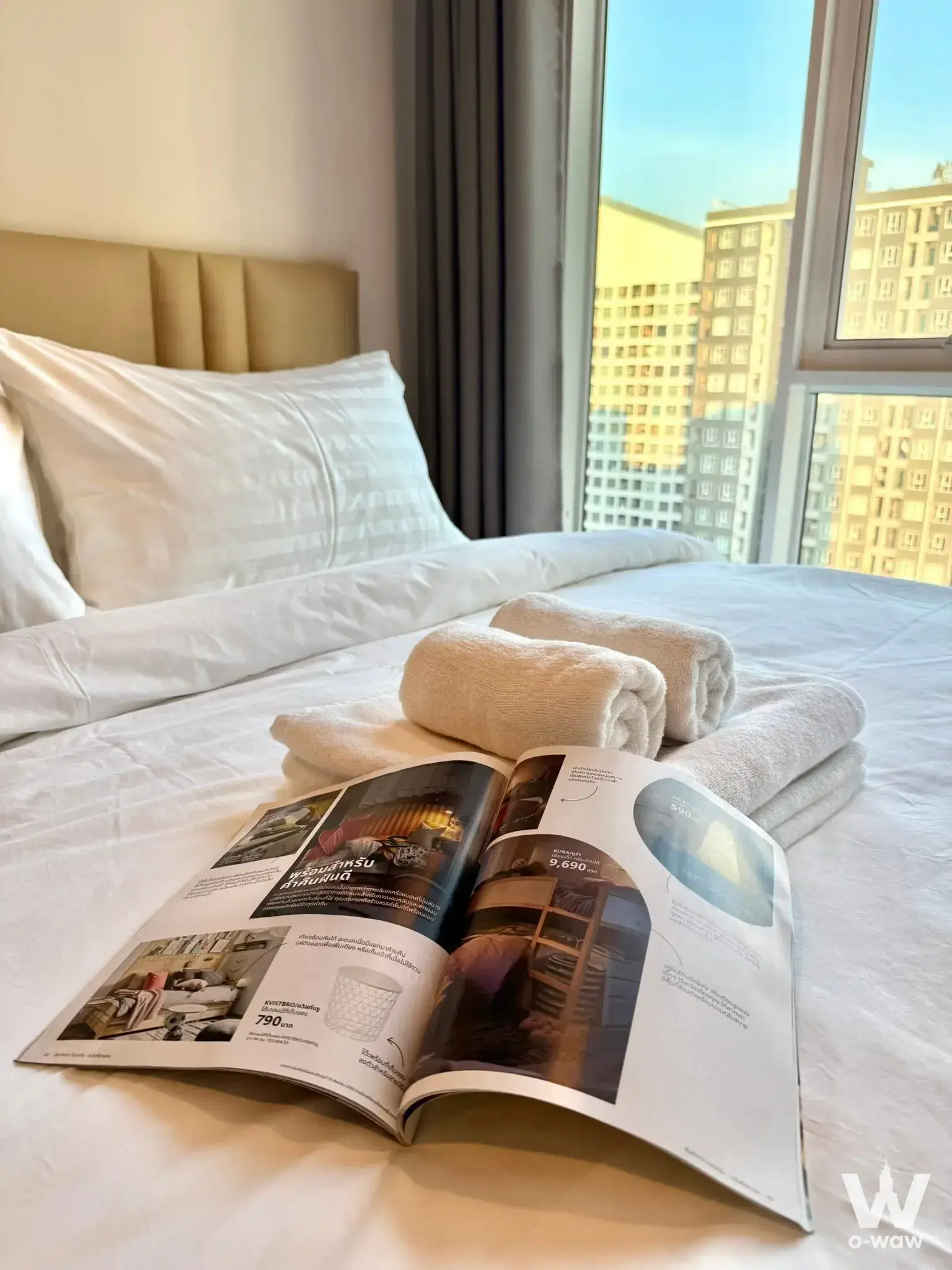 Bedroom in Regent Home Bangna featuring hotel-style bed and city view through large window