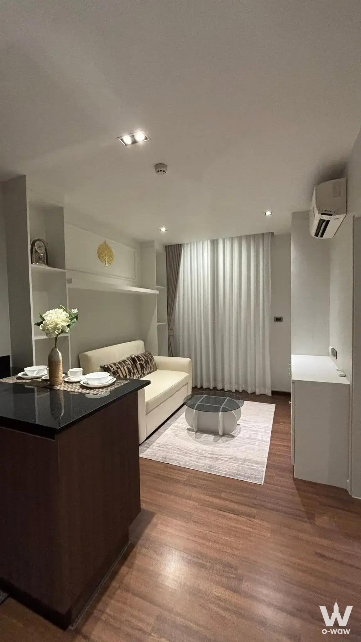 Furnished living room for sale at U CHAROEN RESIDENCE TOWN IN TOWN with dark wood floors and glass coffee table