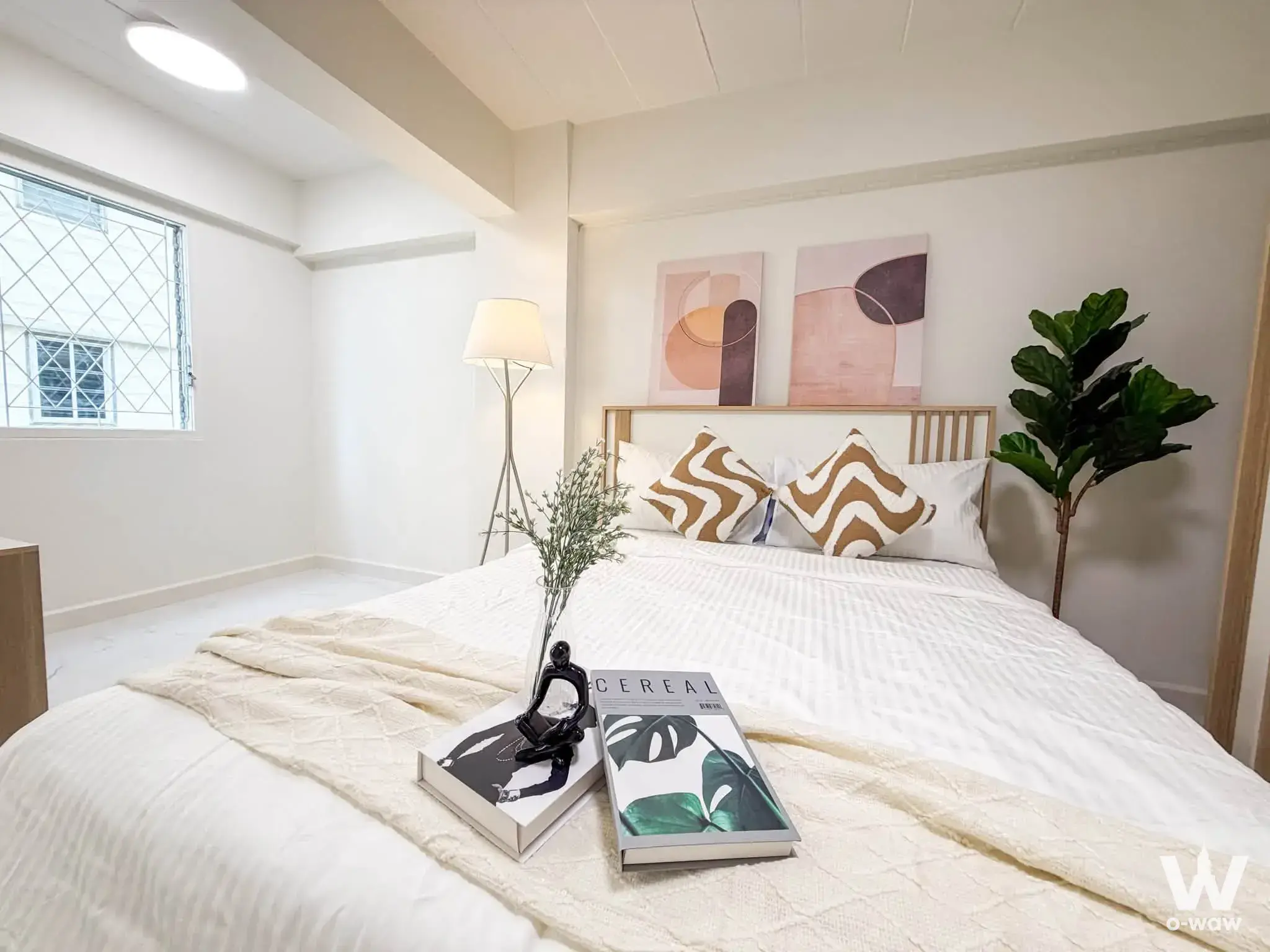 1-bed condo for sale in Phibun Condo Ville with wavy pattern pillows, abstract art, and fiddle leaf fig