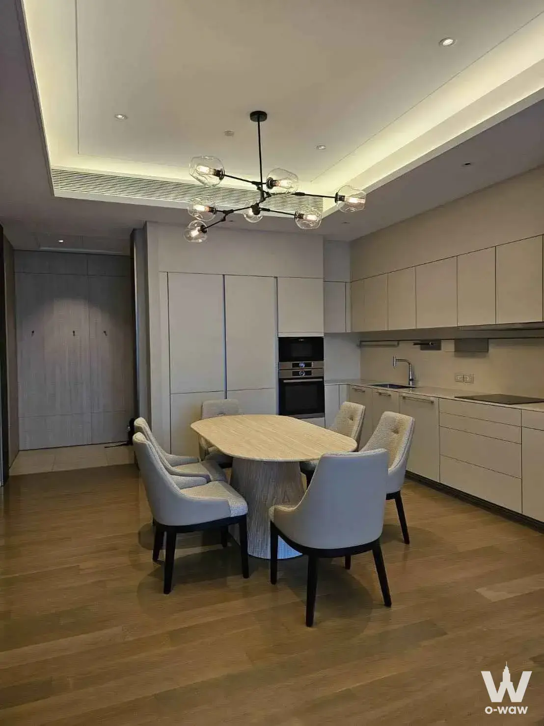 2-bed condo for rent in Baan Sindhorn showing modern dining area with stone table and built-in kitchen